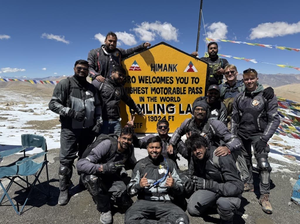 Group celebrating at the highest motorable pass